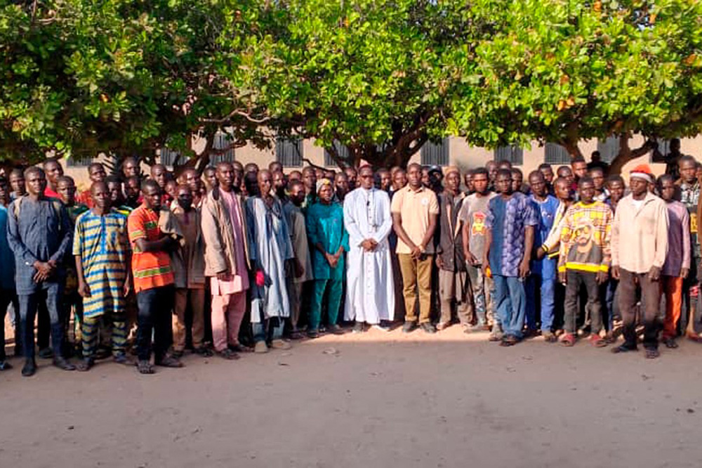   This handout photo taken by Reverend Bulus Dauwa Yohanna, Chairman of the Christian Association of Nigeria (CAN) of Niger state chapter and Catholic Bishop of Kontagora Diocese on November 21, 2025 and distributed on November 22, 2025 shows relatives of abducted children pose for a photograph in the courtyard of St. Mary’s Catholic School in Papiri, Agwarra local government, Niger state. (Photo by Bulus Dauwa Yohanna / Christian Association of Nigeria (CAN) / AFP) 