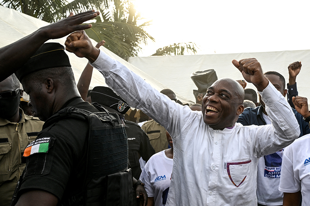 Ivorian independent presidential candidate Ahoua Don Mello is welcomed by his supporters during a campaign rally at the commune of Port-Bouet in Abidjan on October 15, 2025. (AFP)