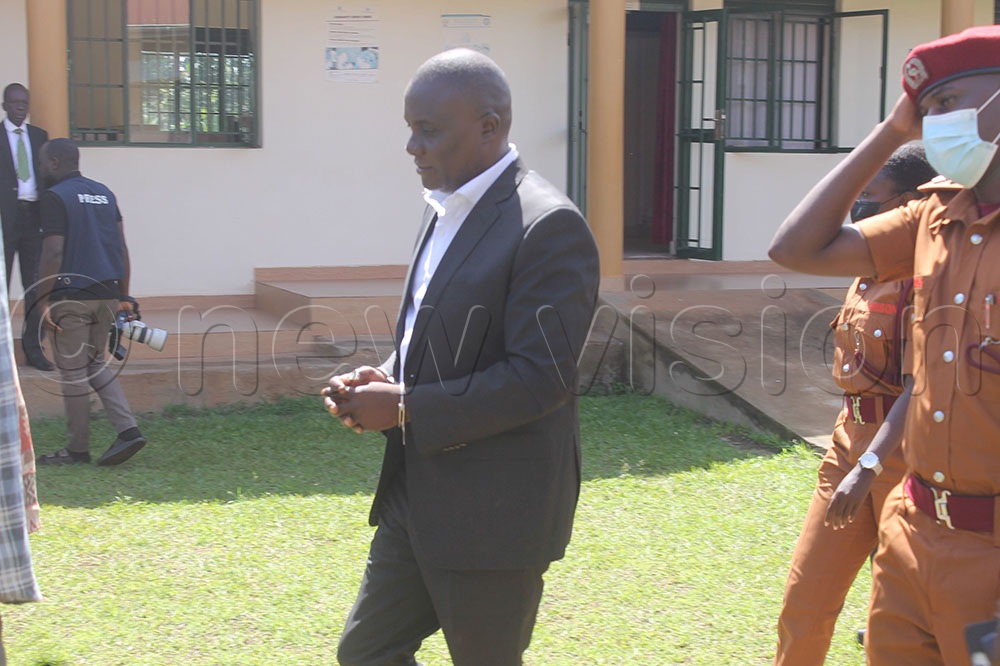 MP Muwanga Kivumbi being led to the court room at Butambala Chief Magistrate Court. (Credit: Simon Ssekidde)