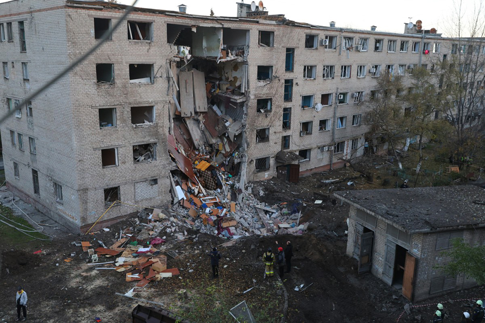 Ukrainian rescuers work at the site of a heavily damaged building following an air attack in Zaporizhzhia on October 30, 2025, amid the Russian invasion of Ukraine. Russian strikes on Ukraine overnight killed one person, wounded 17 and caused emergency power outages across the country, Ukrainian authorities said on October 30, 2025.