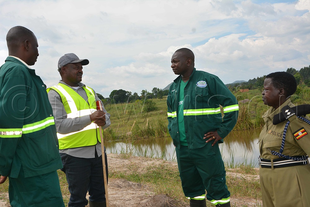  Cypriano Nsabimana NEMA mid-western region inspector (right) sharing with Joseph Garuhanga who rented 10 acres of land to Mechanized AGRO (U) Limited. (Photo by Peter Abaanabasazi)