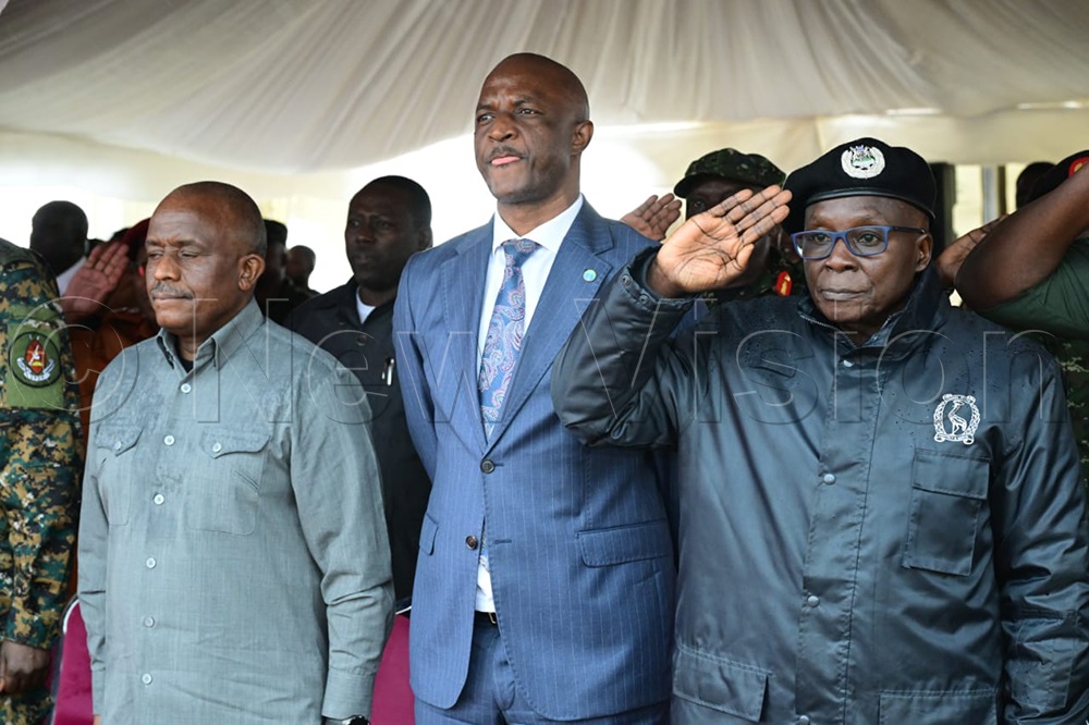 Inspector General of Police Abas Byakagaba (right) with Ministry of Finance Permanent Secretary and Secretary to the Treasury Ramathan Ggoobi (Centre). (Credit: Eddie Ssejjoba)