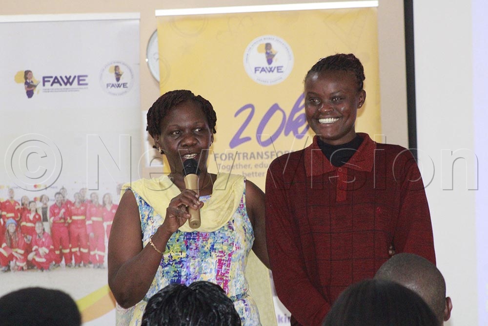 Conslate (right) with FAWE executive director Susan Opok Tumusiime at a TUSEME training recently. (Credit: Ritah Mukasa)