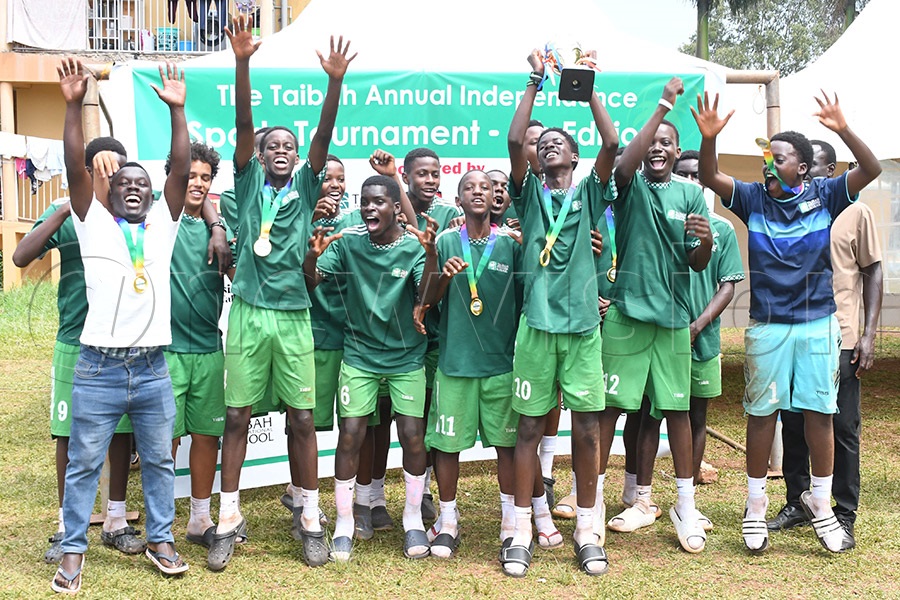 Taibah International School's U-15 football team celebrate with their trophy after the Independence tournament. Photo by Michael Nsubuga