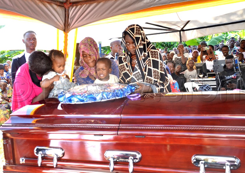 Some of the bereaved children of John Bosco Ssenyonjo aka Bitanda during the burial at Kasana-Kyalusowe in Masaka City. (Photo by Dismus Buregyeya)