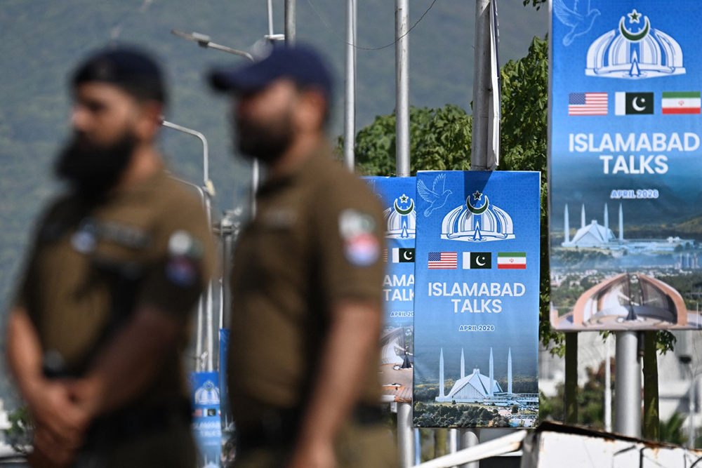 Security personnel stand guard at a checkpoint near the Serena Hotel at the Red Zone area in Islamabad on April 21, 2026, amid heightened security measures ahead of anticipated US-Iran peace talks. 