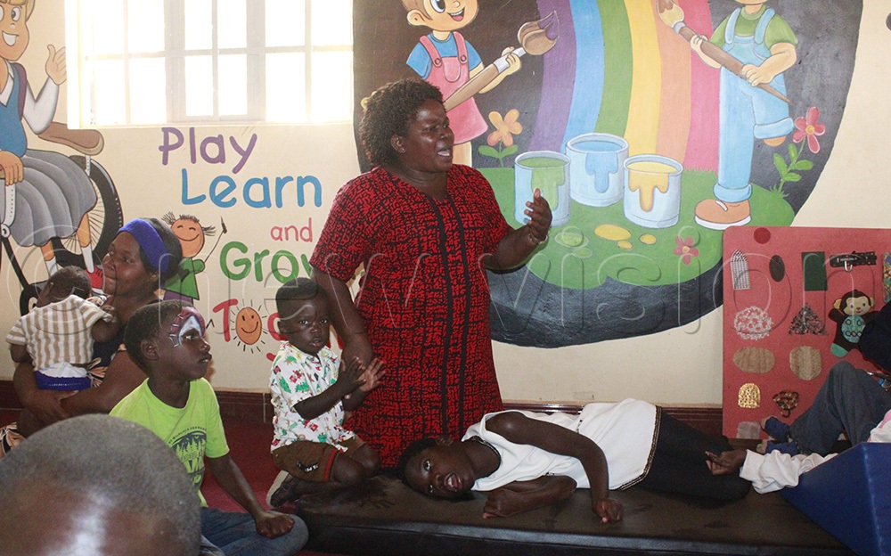 Rebecca Nankinga the headteacher of Sentema Church of Uganda Primary School with children inside the shelter. (Photo by Ritah Mukasa)