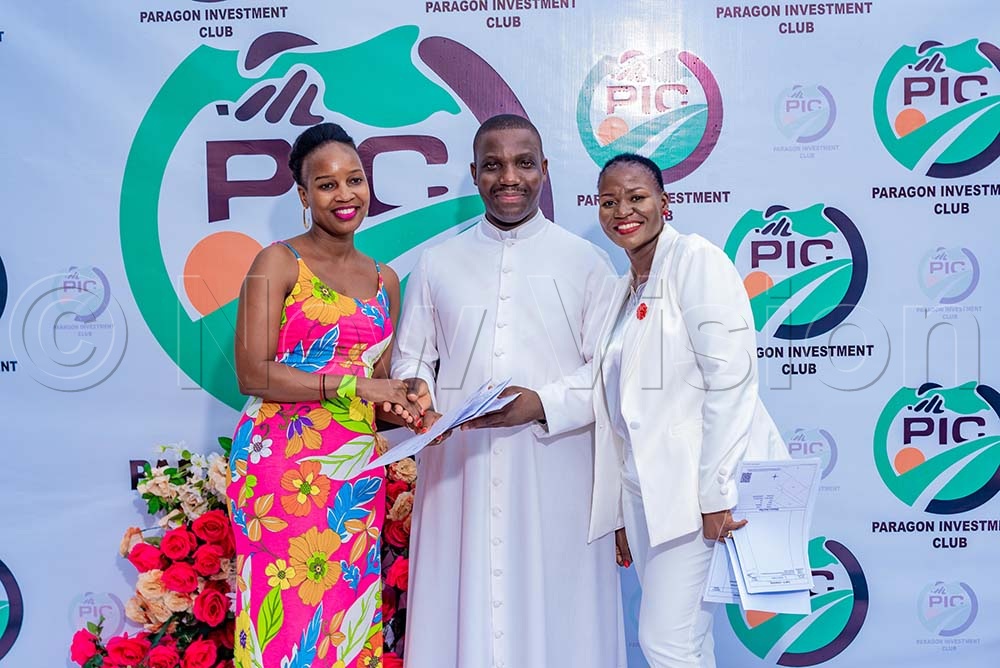Father Kiibi congratulates Diana Rose Naiga upon receiving four titles. Standing right is Florence Nambooze Bbale, the club founder. (Credit: Ritah Mukasa)
