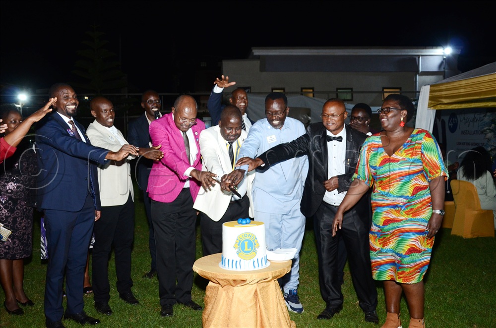 Lions cutting cake to celebrate the installation of the fourth president of the Entebbe Road Lions Club. This was during the fourth presidential and board installation dinner at Orion Restaurant Lweeza on June 27, 2026.