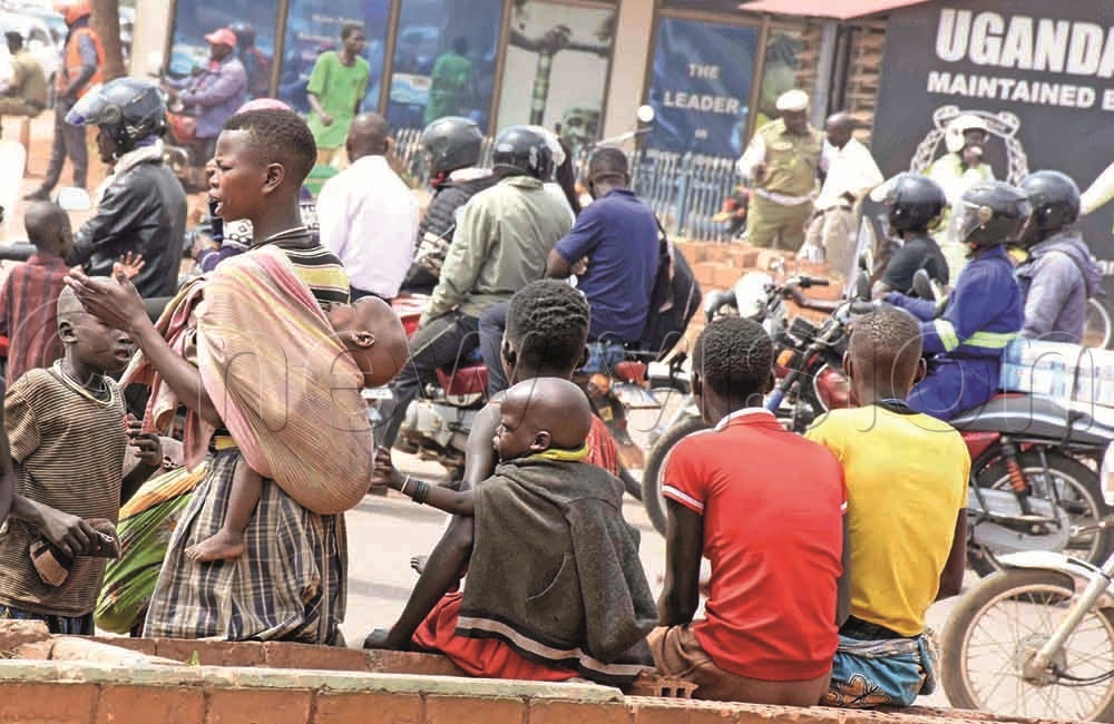 Children begging by a pavement on Jinja Road.