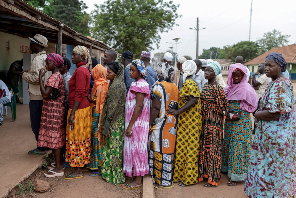 Voters queue outside a polling station before polls open at the Gabu Maternal and Child Center polling station in Gabu on November 23, 2025 during Guinea-Bissau's presidential and legislative elections. (Credit: AFP)