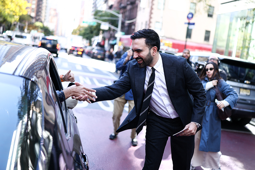 Democratic socialist candidate Zohran Mamdani greets people on the street in the Manhattan borough of New York City during early voting for the upcoming mayoral election, on October 27, 2025. (Photo by CHARLY TRIBALLEAU / AFP)