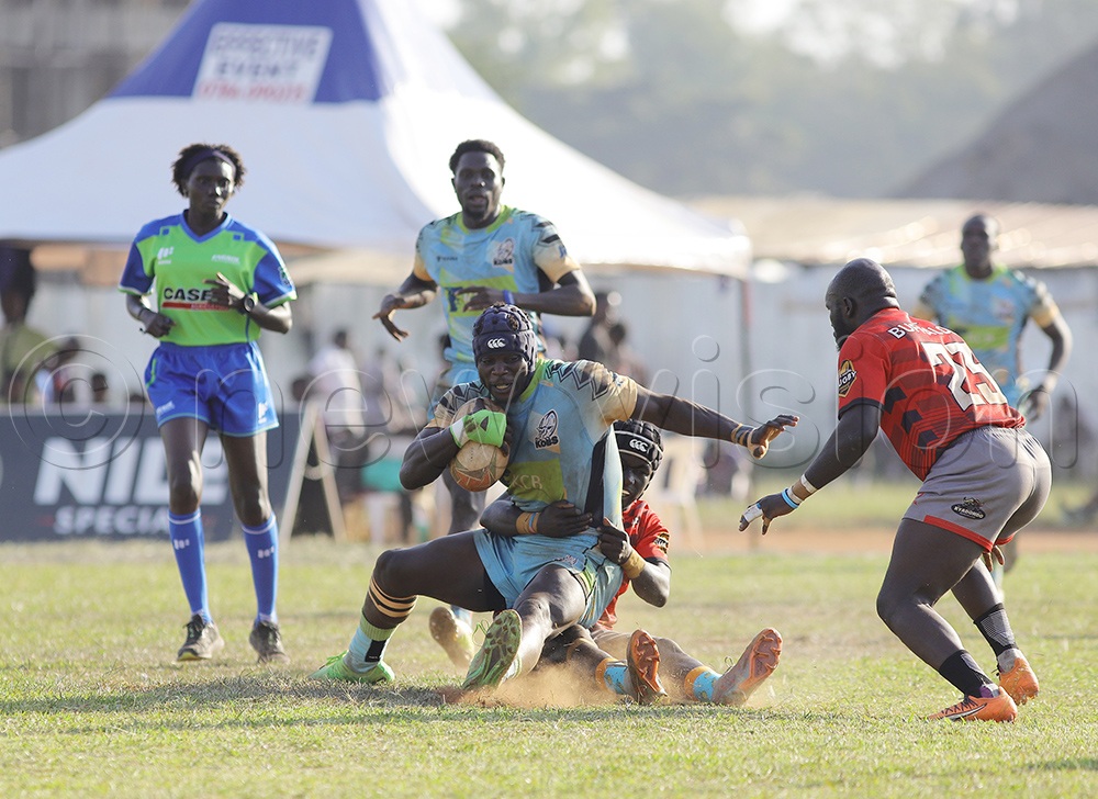 KCB Kobs. Brian Wandera with the ball, tackled by Buffaloes opponents. (Photo by Johnson Were)