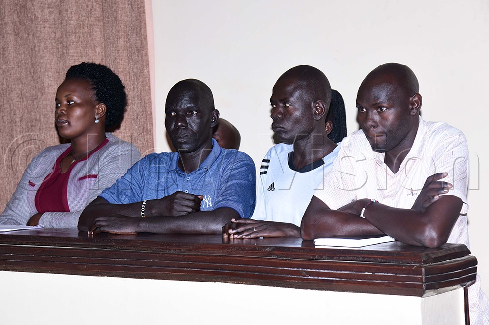 From left: Ariokot, her husband Okedi, H.M. Edoket, and Police Officer Obotol appear in the dock during court proceedings this afternoon. (Credit: Godfrey Ojore)