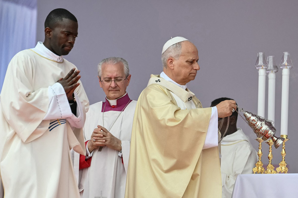 Pope Leo XIV (R) swings the thurible as he leads a Holy Mass in Kilamba on the seventh day of an 11-day apostolic journey to Africa, on April 19, 2026. 