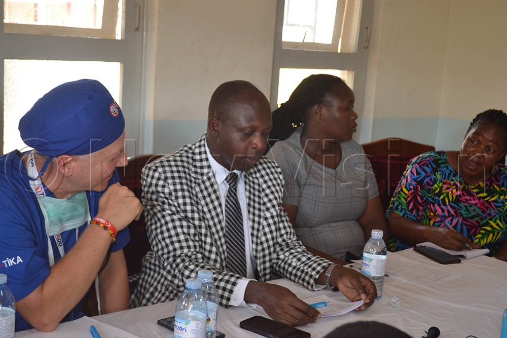 Suzan Kulaba Barungi, who delivered the minister's speech, poses with former MP Manjeri Kyebakutika, Dr Alfred Yayi, and a Turkish medical expert during the press briefing. (Credit: Doreen Musingo)
