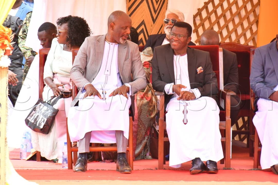 Busoga Kingdom Prime Minister Dr Joseph Muvawala (left) chats with Buganda Kingdom Prime Minister Charles Peter Mayiga (right) during the 12th Kyabazinga Coronation Anniversary celebrations in Mayuge.