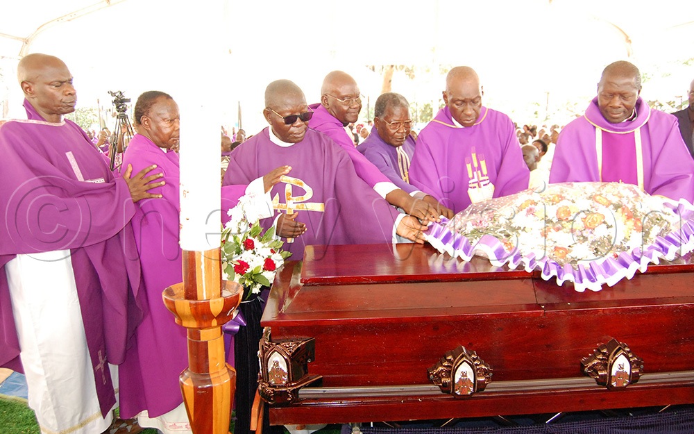 Fr. Ssewava's classmates (the centenary priests), who included Msgr. Dominic Ssengooba (right), Fr. Joseph Muksasa Nkeera (second from right) and Fr. Joseph Mary Ssekalegga (fourth from left) laying a wreath on the casket containing his remains during the requiem Mass at Kisubi Minor Seminary on Monday, September 28, 2026. (Photo by Mathias Mazinga)
