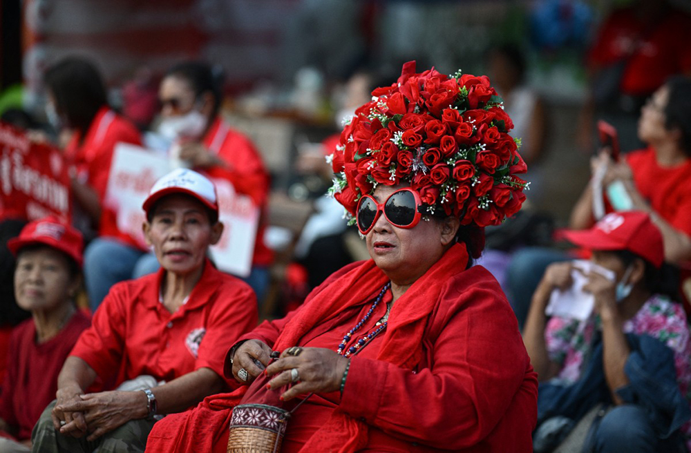 Supporters of Thailand's former prime minister Thaksin Shinawatra wait ahead of his expected release at Klong Prem Central Prison in Bangkok on May 11, 2026. (AFP)