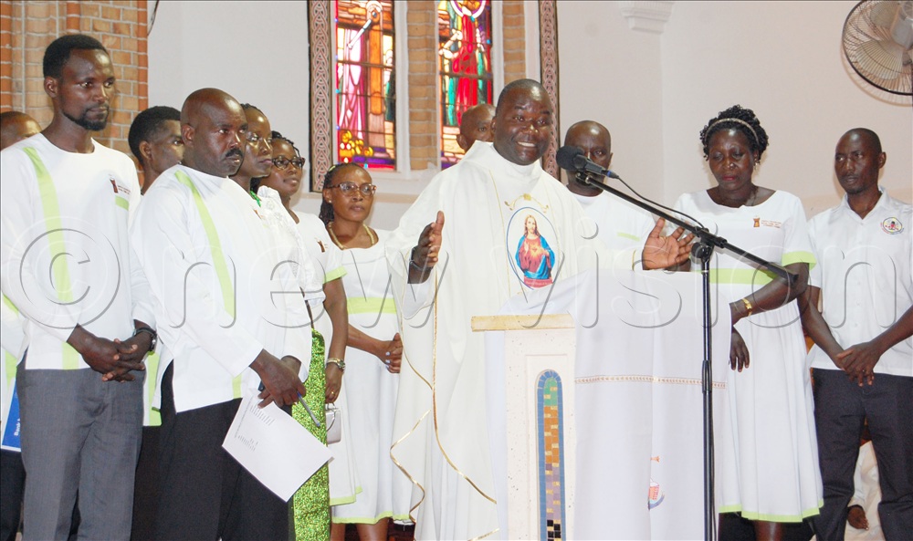 The Director of Kampala Archdiocese Social Communications Department, Fr. Joseph Mukiibi (spreading arms) delivers his message of thanksgiving. With him are some of the members of his team.