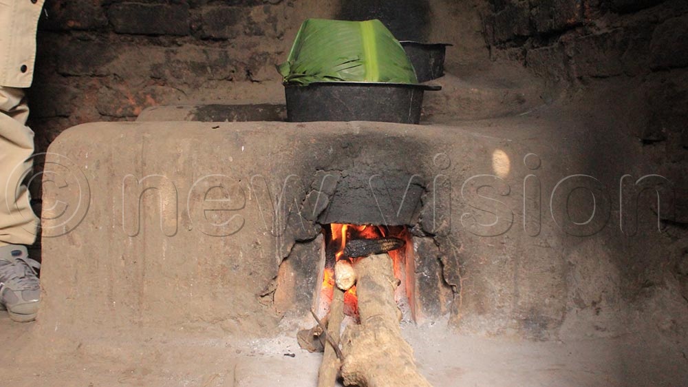A resident near Kasyoha-Kitomi prepares food using firewood from the forest. (Credit: Bruno Mugizi)