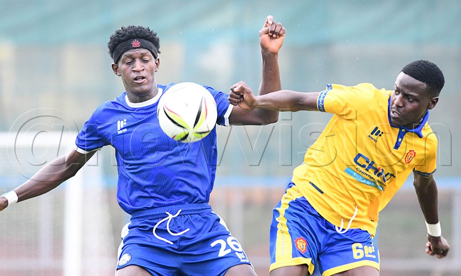 KCCA FC's Lazaro Muhindo (right) controls the ball ahead of Police FC's Richard Matovu during a Uganda Premier League match at Kira Police Ground. Photo by Michael Nsubuga