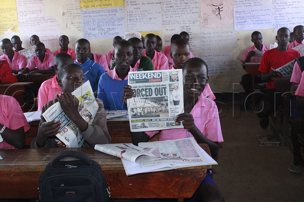 Primary Six pupils at Acet Primary School use newspapers as revision materials. (Credit: Ritah Mukasa)