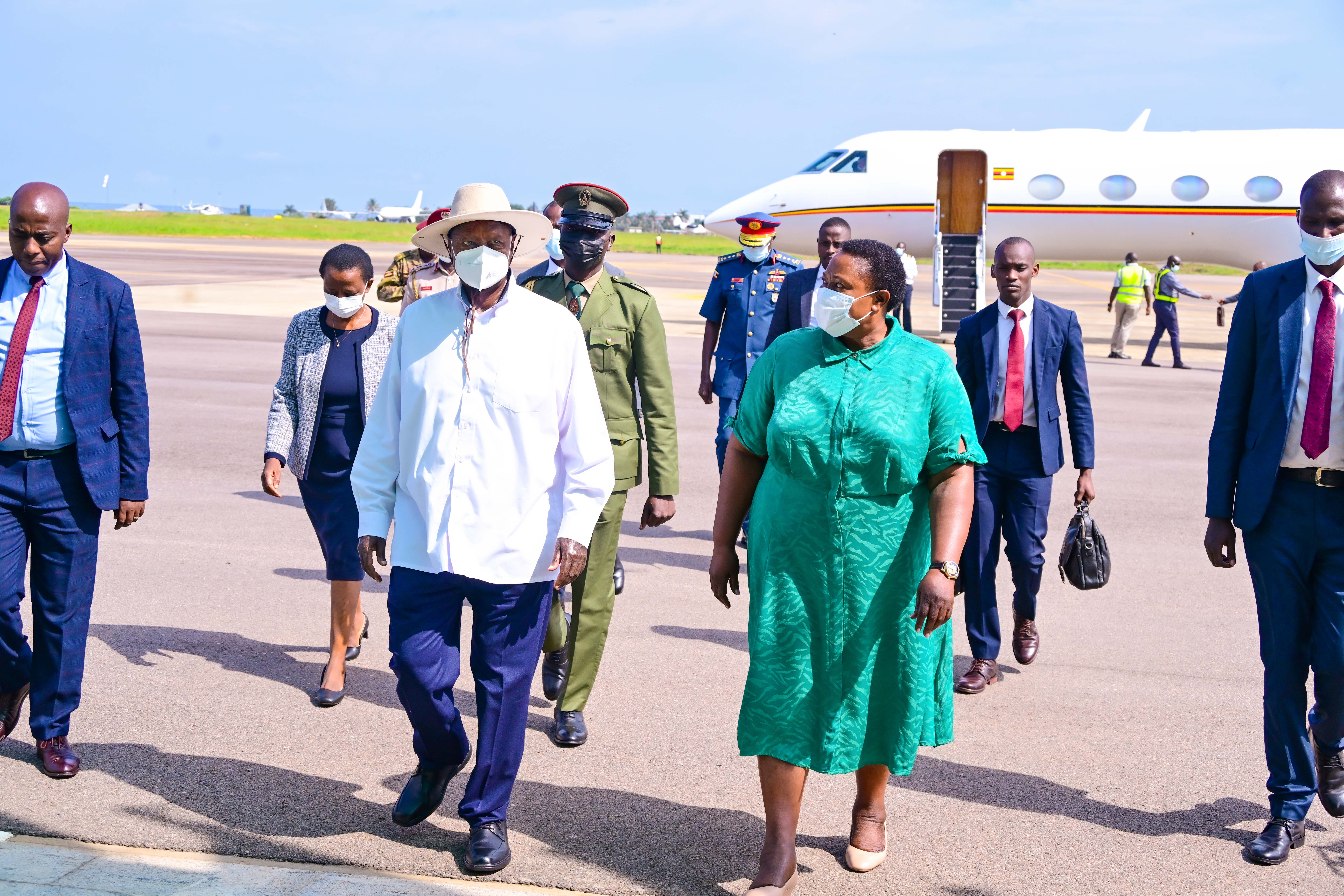 President Museveni chats with minister Milly Babalanda on his arrival at Entebbe International Airport. PPU Photo. Courtesy/PPU