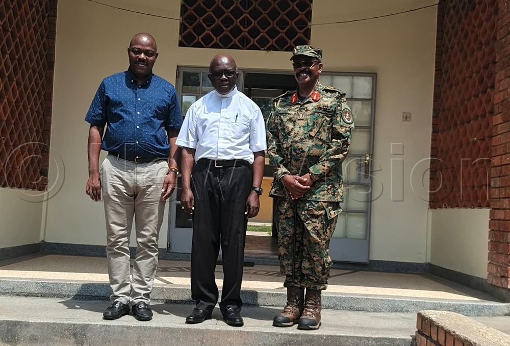 Bishop Hoima Catholic diocese, Kirabo centre, posing for a photo with Henry Wabyona, President&rsquo;s Private Secretary on Political and Diaspora Affairs and Maj. Gen. Leopold Bunyoro's deputy National Security Task Force. (Photo by Peter Abaanabasazi)