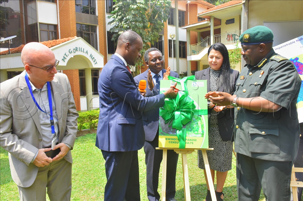 Tourism State Minister Martin Mugarra (2nd left), launching the Chimps in Bwindi impenetrable national park, at a function held on Tuesday at UWA headquarters.