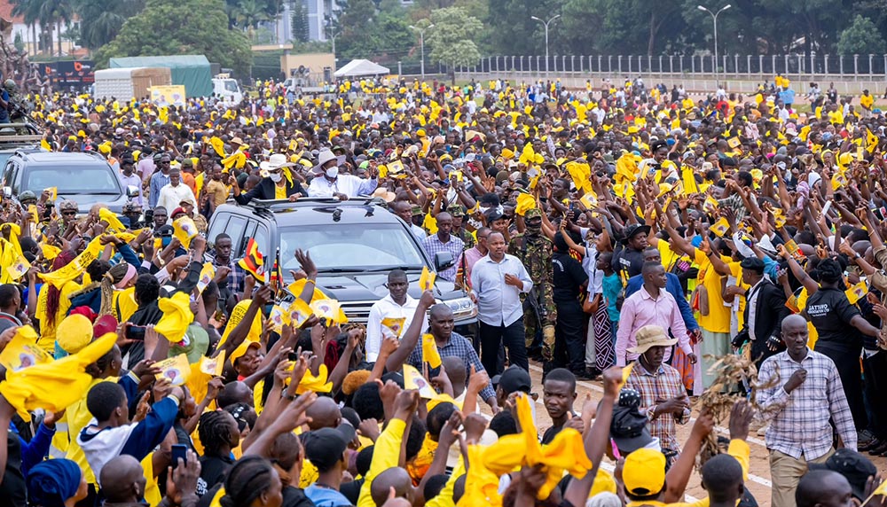 NRM supporters receiving President Museveni (standing through car sunroof) as he arrived for a rally.