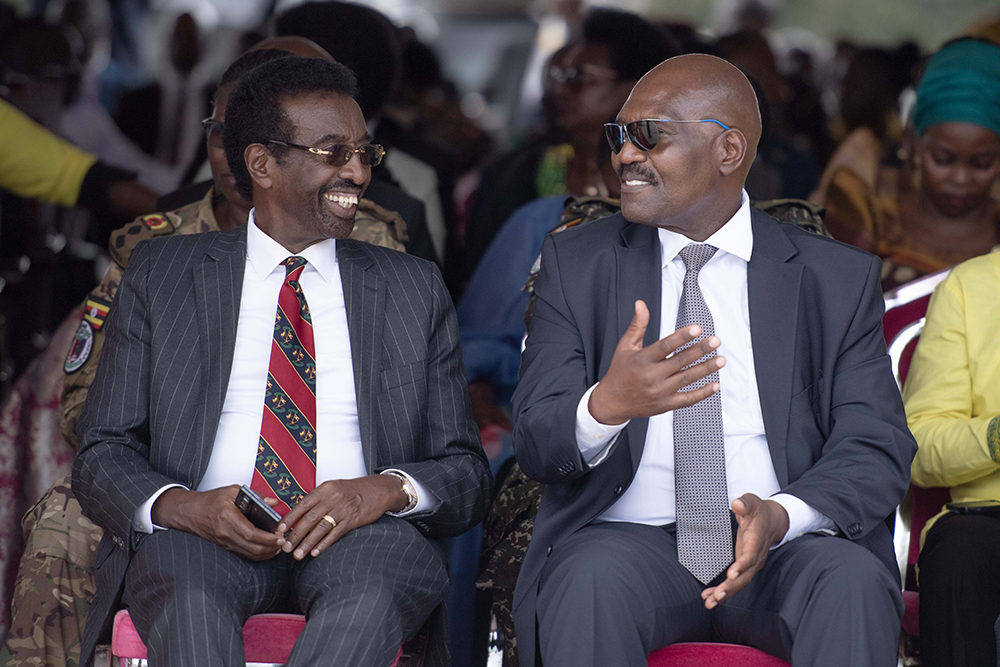 Col Mande having a light moment with Major General (retired) Jim Muhwezi, the minister of security. (PPU)