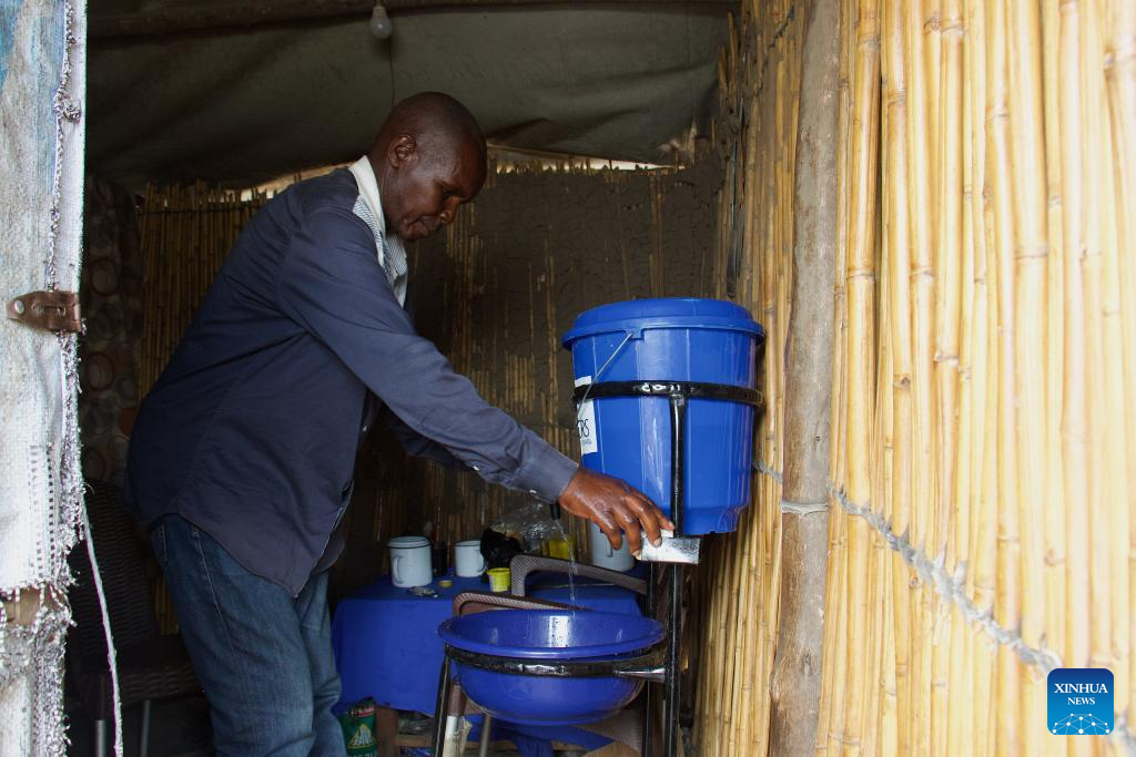 A man installs a hand-washing station in the Kigonze camp for internally displaced people (IDP) on the outskirts of Bunia, Ituri Province, the Democratic Republic of the Congo, June 9, 2026.