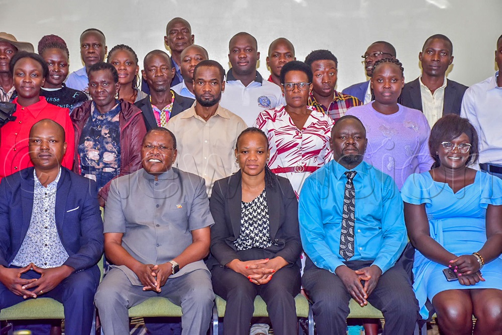 Dr Maxwell Otim, the commissioner in charge of Entomology in the ministry of Agriculture, Animal Industry and Fisheries (MAAIF) (fourth on left) in a group photo with farmers, facilitators and funders. (Photo by Sharon Nabasirye)