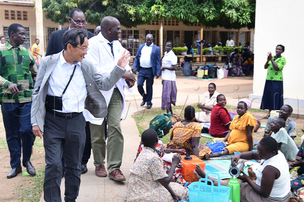 Ambassador Takuya Sasayama waves at the caretakers of patients as he tours the hospital after handing over equipment to the facility's leadership. (Credit: Godfrey Ojore)