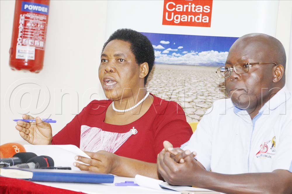 Betty Aguti, Caritas Uganda policy and advocacy officer, Giregon Olupot, from the department of agriculture production of Makerere University speaking during the conference.