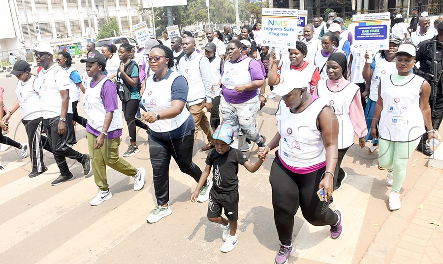 UJOA president Daphine Ayebare (center) and the deputy chief justice of Uganda Justice Moses Kazibwe Kawumi (2nd left) and UJOA members participate in the Judges Walk at the High Court. Photo by Michael Nsubuga