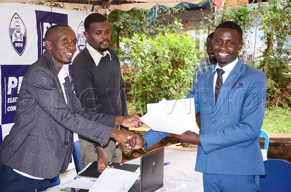 The Kampala University lecturer, Aliban Rukundo receives expression of interest forms at Plot 6 Katonga Road in Nakasero Kampala. (Credit: Isaac Nuwagaba)