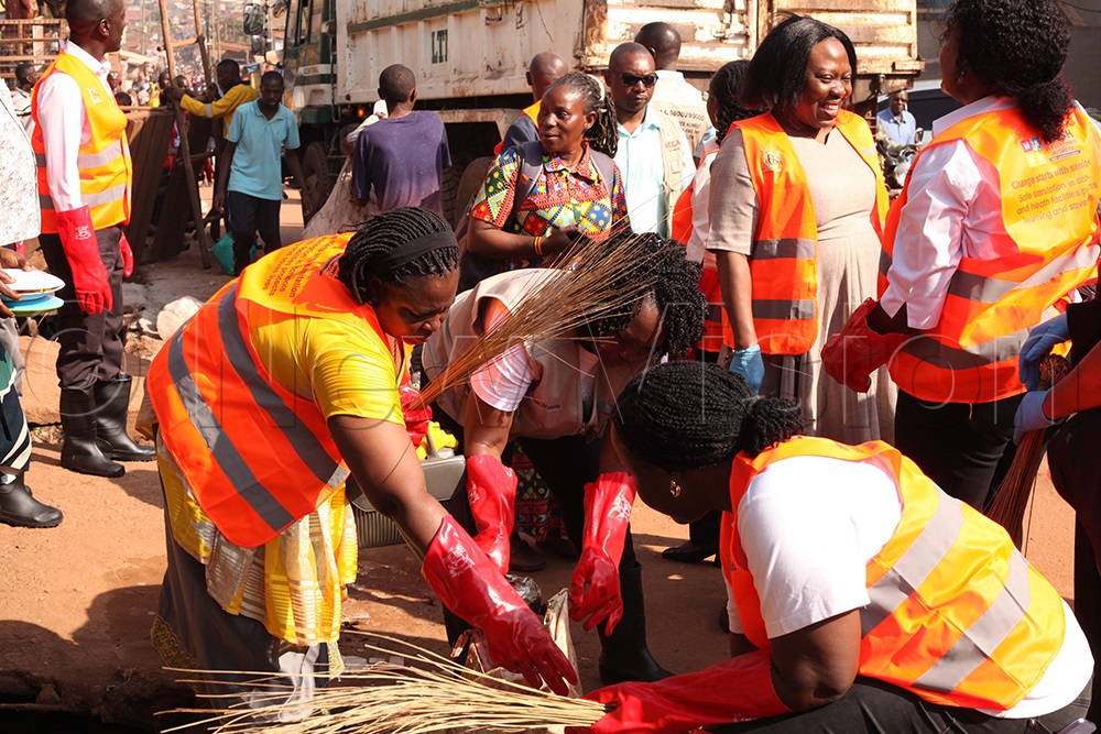 KCCA cleaners and officials cleaning Kamwokya parish 1. (Credit: John Musenze)