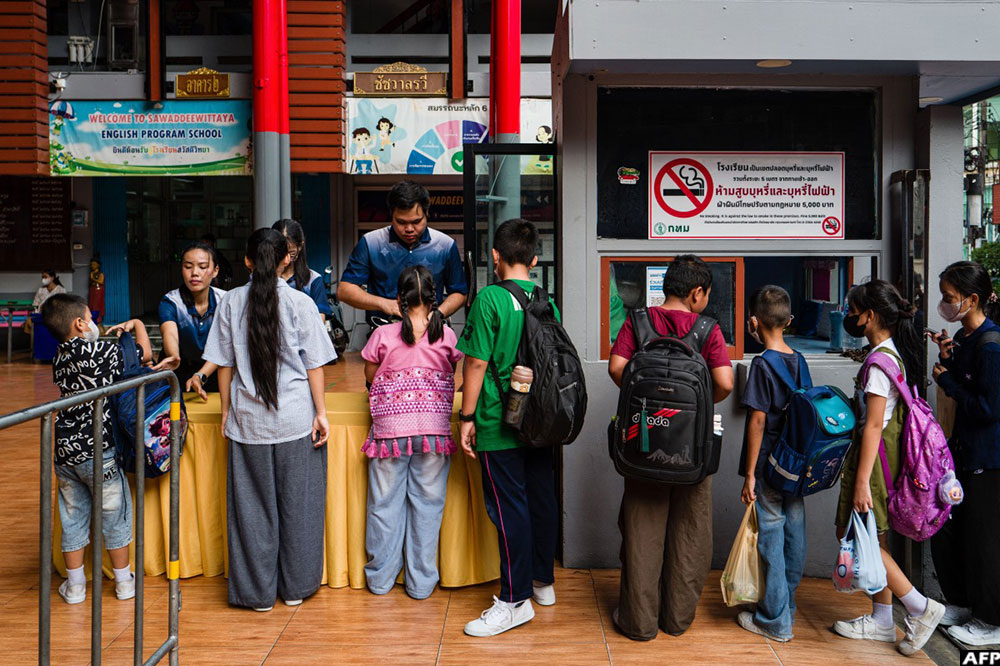 Dozens of students queued at a Bangkok school, handling backpacks to teachers for security checks, a week after a deadly shooting in one of Thailand's worst attacks in recent years.