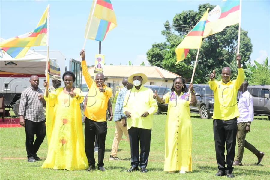 President Yoweri Museveni (C) with Ngora district MP and LC5 flagbearers after presenting them with party flags during a campaign rally at BKC Demo Primary School.