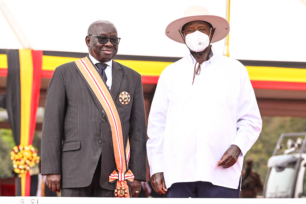 Retired High Court Judge Ralph Ochan poses for a photo with President Museveni after being decorated with the Grand Command Order of the Nile award  during the NRM Liberation day celebrations at Kololo on Monday. (PPU Photo) 