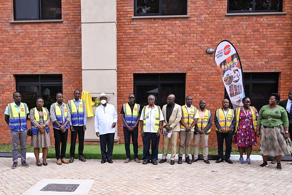 President Museveni shares a photo moment with some of the engineering and State House Estates staff after  commissioning the SFC detach dormitory at Nakasero on Wednesday. Also in photo is State House Comptroller.
