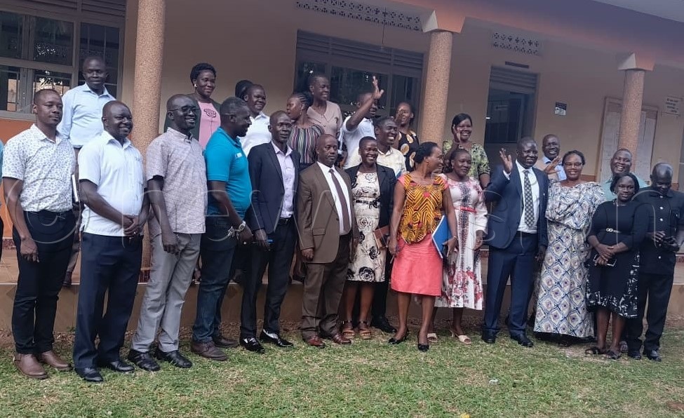 Okwonga (4th right) in a group photo with Gulu City staff.