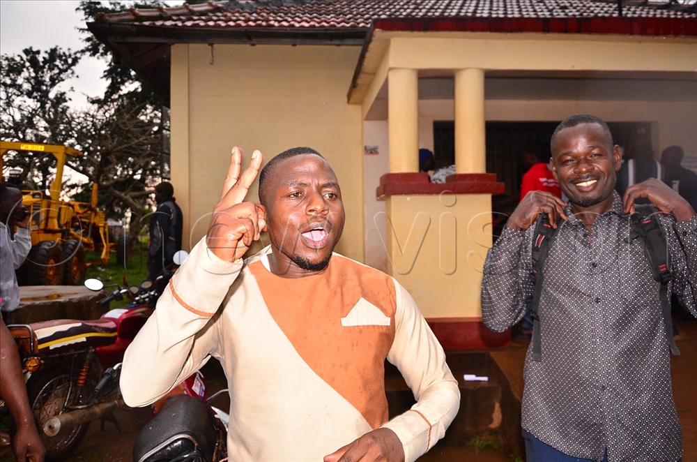 Abdurahman Mujoma flashing the FDC sign as he traversed Muguluka trading centre in Jinja district on Tuesday. 
