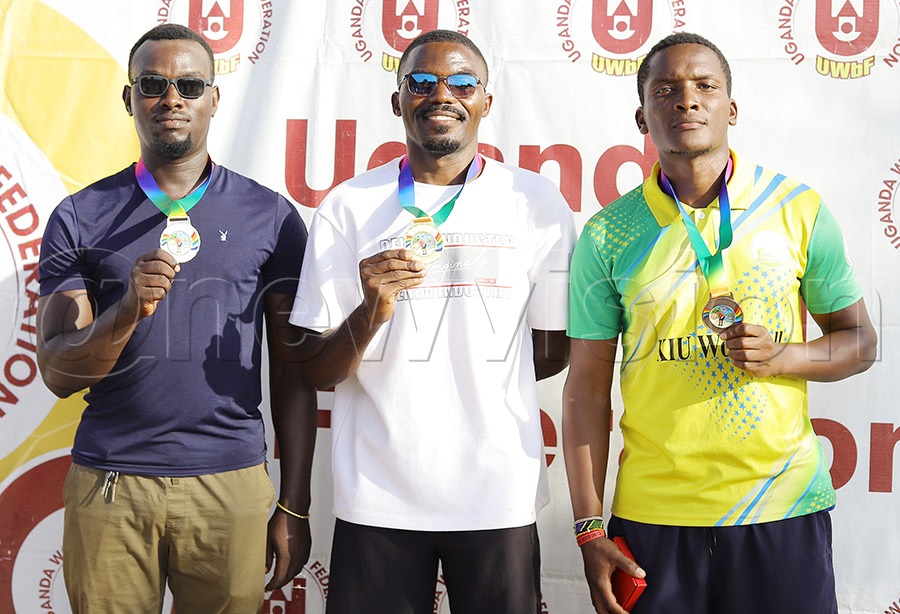 Winner Brian Gwaka (C), Bridge Byamukama (R) -Bronze and .Edson Twesigye (R) -Silver shows off their medals after winning the second round of the National Beach Woodball Circuit in Bunjako on Sunday