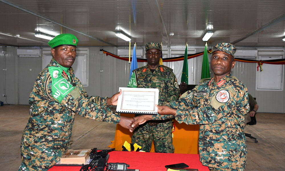 Incoming commander, Col Justus Musenene of Battle Group XLV (right), receiving a handover report from his predecessor. (UPDF Photos)