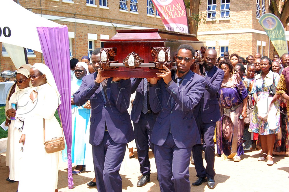 Pallbearers carrying the coffin containing Fr. Ssewava's remains to the priests' cemetery at Kisubi Minor Seminary. (Photo by Mathias Mazinga)