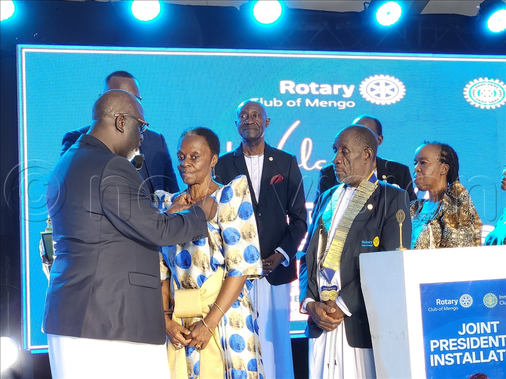 (L-R) Robert Waggwa Nsibirwathe the Second Deputy Katikkiro of Buganda Kingdom and Minister for Finance, who is also a Past District Governor presenting Buganda Kingdom princess Nnaalinnya Dr. Catherine Agnes Nabaloga with an honorary membership pin as Fred Kafeero the president of the Rotary Club of Mengo and the out going club president Ronald Migadde and other guests look on, This was during the double installation ceremony of the new president of the Rotary Club of Mengo and the president of the Inner Wheel Club of Mengo held at Pope Paul Memorial Hotel in Kampala on May 17, 2026.