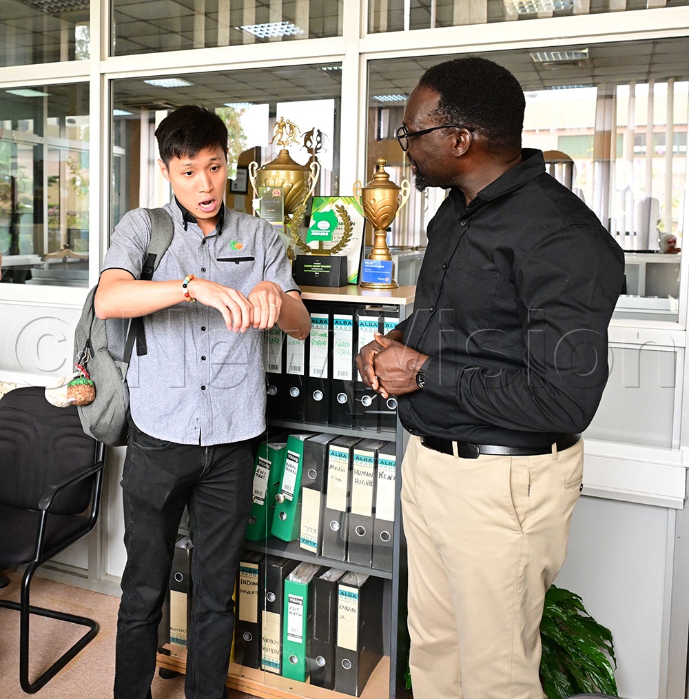 Nick Wong speaking to Sydney Miria. (Photo by Eddie Ssejjoba)